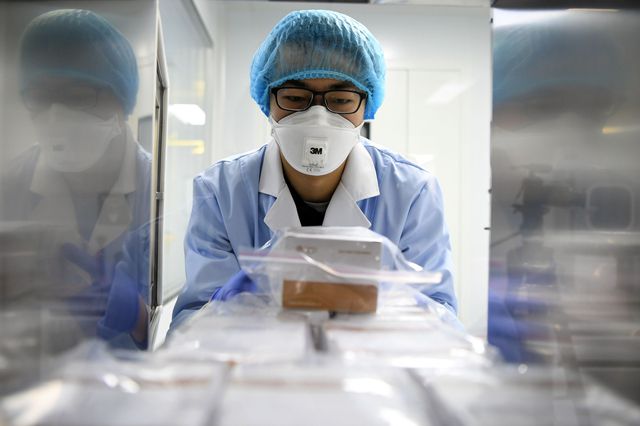 A researcher delivers the 2019-nCoV (the latest Coronavirus strain) detection reagents at a company in Wuqing District, north China's Tianjin Municipality.